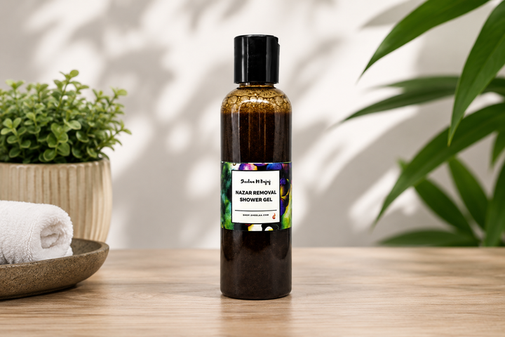 Nazar Removal Shower Gel by House of Sheelaa in a dark bottle with a colourful label, styled in a calm spa setting with greenery and soft natural light.