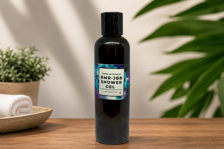 **Alt text:** BMR-JBB Shower Gel by House of Sheelaa in a sleek dark bottle, styled on a wooden surface with soft greenery and spa-inspired décor.