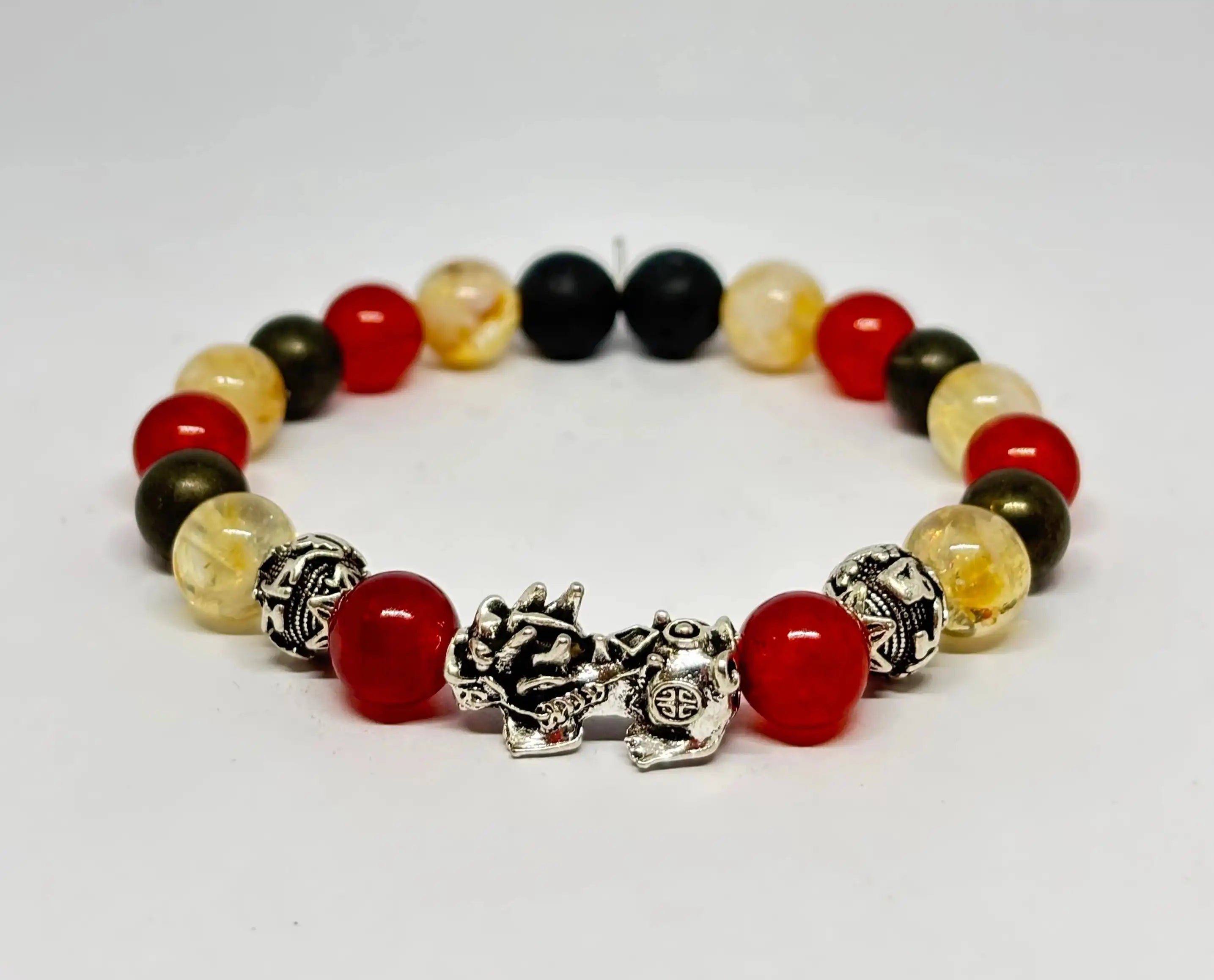 Sheelaa Wealth Crystal Bracelet with Pixiu Citrine Carnelian and Pyrite beads on dark velvet