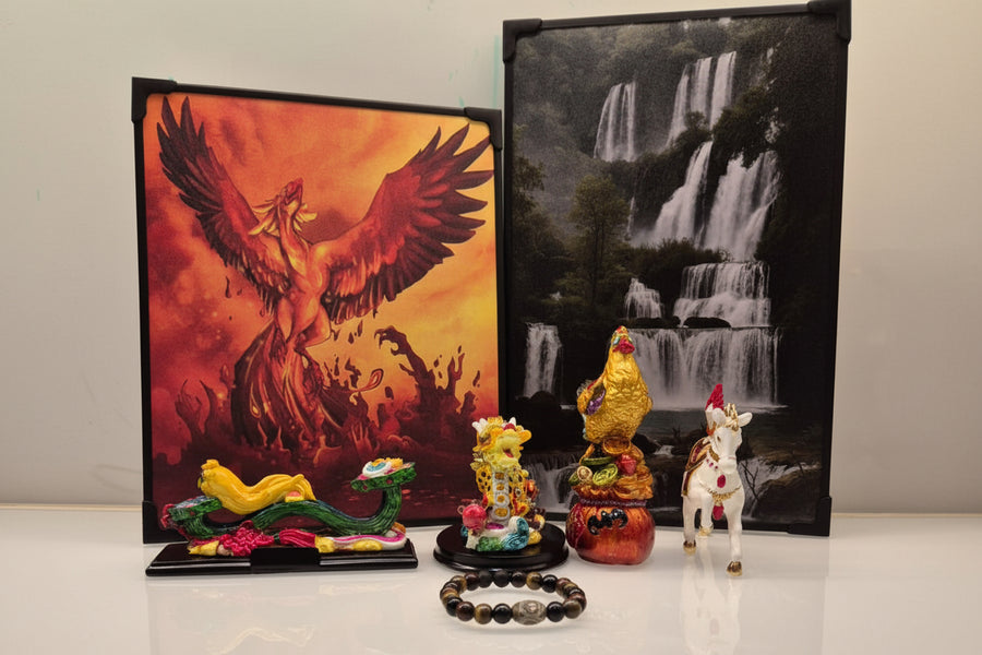 Collection of decorative items including statues and a bracelet, with two artworks in the background.